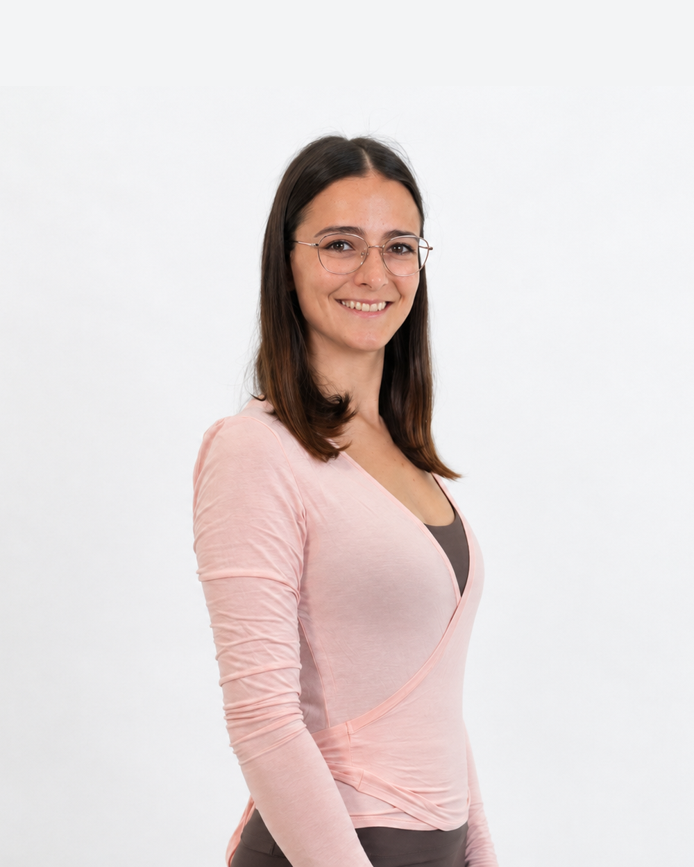 Samira, a workshop facilitator, facing the camera in a studio portrait with a plain light background